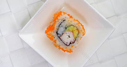 Rotating crab avocado Sushi roll on plate