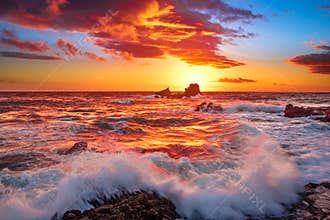 Fire Sky and waves crashing over rocks in Laguna Beach, CA