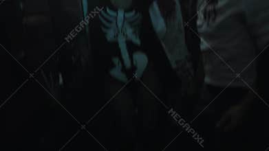 Girl in skeleton costume and face paint dance at halloween night club party