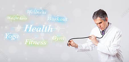 Clinical doctor pointing to health and fitness collection of words