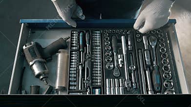 Mechanic open Blue Metal Box with Different Tools for Car Repair at Modern Service station