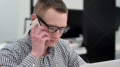 Efficient businessman answering phone call at the office