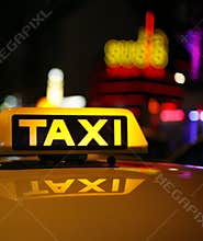 Yellow taxi sign on car roof