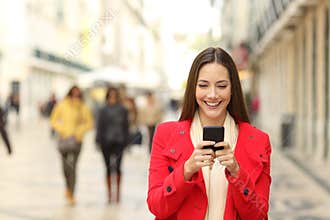 Fashion woman using a smartphone in winter