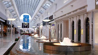 Motion of fountain water with blur people shopping