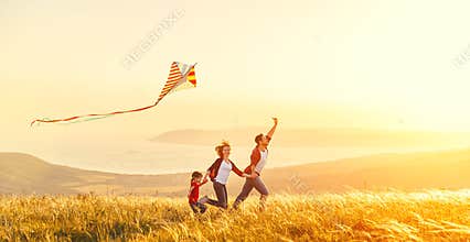 Happy family father of mother and child daughter launch a kite o