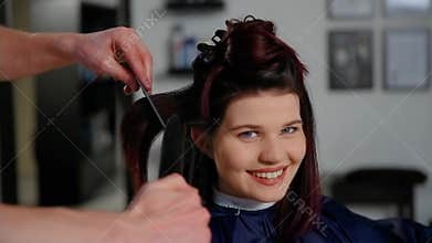 Reflection of hairdresser doing haircut for woman in hairdressing salon. Concept of fashion and beauty
