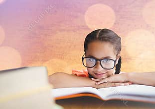 Girl at desk with books against map with bokeh