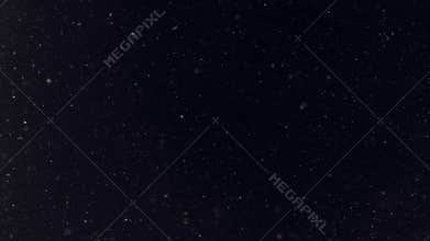 Turbulent snowfall on black background as winter season weather background