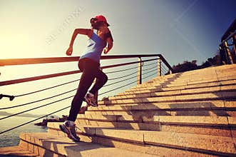 Healthy lifestyle sports woman running up on stone stairs