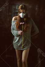 Young pretty female wearing respirator, allergy concept