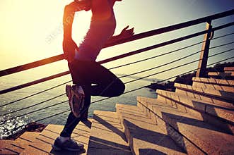 Healthy lifestyle sports woman running up on stone stairs sunrise