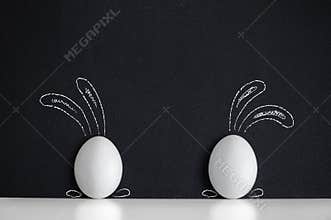 Easter eggs painted like rabbits on the black background