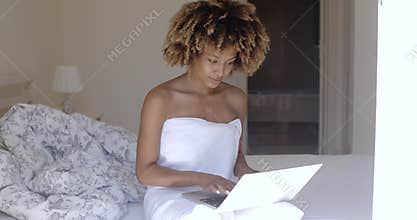 Young Woman Using Laptop On Bed