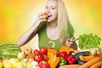 Smiling woman eating fruit