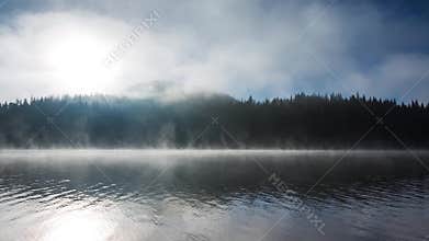 Beautiful sunrise and fog over the mystic mountain lake, video