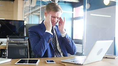 Tired and stressed businessman is working in his office
