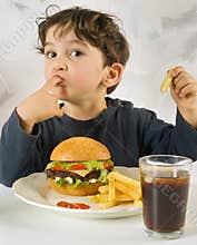 Young boy eating chessburger
