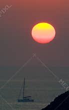 Sunrise over boat in ocean