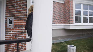 Beautiful blonde shows the keys to their new apartments in a stylish brick house. She is happy