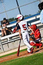 Youth baseball boy about to bat looking at pitcher.