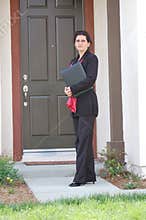 Real Estate Agent In Front of Home