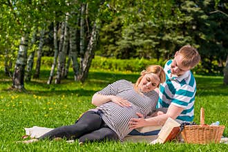 Woman and a man spend their free time at the picnic