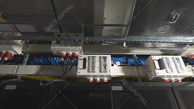 Several electric power units are equipped with a switch inside, attached under the ceiling in the industrial premises of