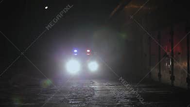 Police Car Patrolling the City At Night.