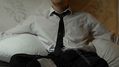 Frustrated man sitting on sofa looking through bank statements, bankruptcy