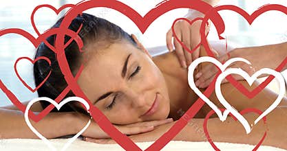Masseuse doing massage to relaxed attractive women at spa with hearts for valentines day 4k