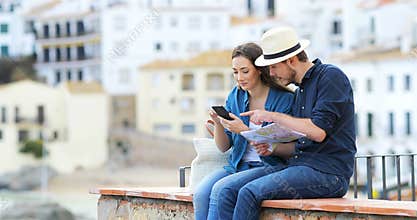 Couple of tourists browsing booking hotel on vacation