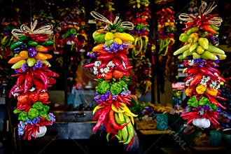Colorful peppers and garlics hanging at market