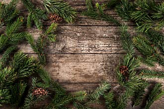 Holiday background of Christmas fir branches, spruce, juniper, fir, larch, pine cones with light
