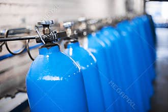 Oxygen cylinder with compressed gas. Blue Oxygen tanks for industry. Liquefied oxygen production. Factory