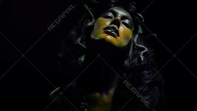 Creepy Medusa Gorgon plays with a snake in her mouth