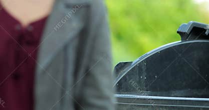 Woman hand throwing crumpled paper into trash container