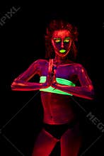 Portrait of a beautiful young girl with ultraviolet paint on her body. Pretty woman with glowing bodyart in black