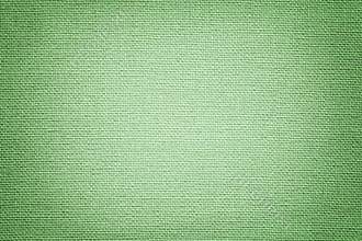 Light green background from a textile material. Fabric with natural texture. Backdrop