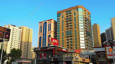 Drive by modern skyscrapers, towers and fast food restaurants