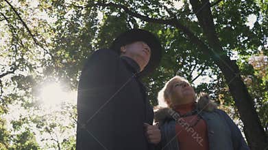 Old couple look up at the park
