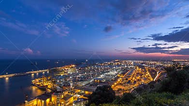Seaport and loading docks at the port with cranes and multi-colored cargo containers day to night timelapse