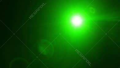 A beam of green light from a profile spotlight directed onto the stage in total darkness