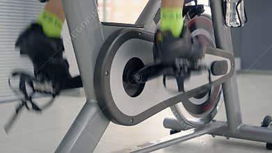 Woman feet during cycling workout.