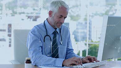 Caucasian doctor working over computer then looking camera with smile