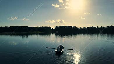 Top view of happy couple in a boat on lake.
