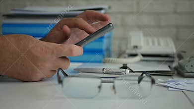Businessman in Office Room Using Cellphone Technology Text Financial Information