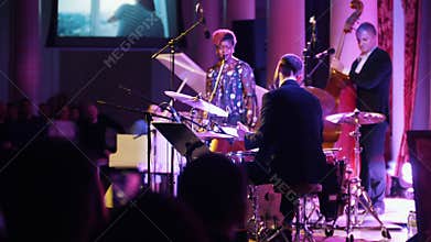 KAZAN, RUSSIA. 30-03-2019: A jazz concert. African-american woman singer on the stage with the rest of the band. Back