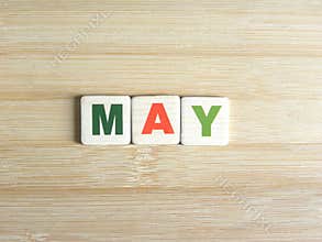 Word May on wood background