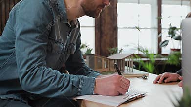 Man sign mortgage contract, put signature on sale purchase rental agreement, handshaking realtor at meeting with estate